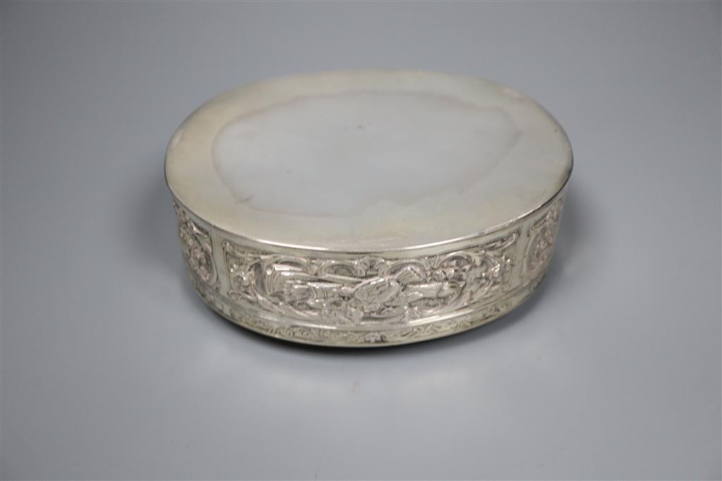 A late 19th/early 20th century German embossed 800 white metal oval box with hinged cover, 13.4cm,